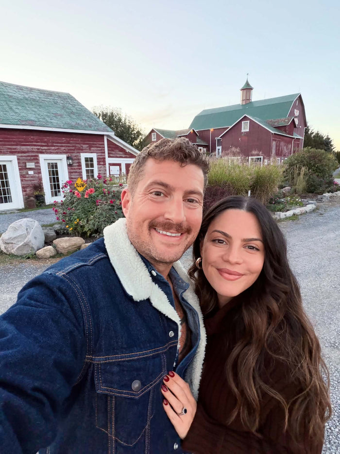 Jules and Frankie taking a selfie in front of the red barns at The Eddie Hotel and Farm