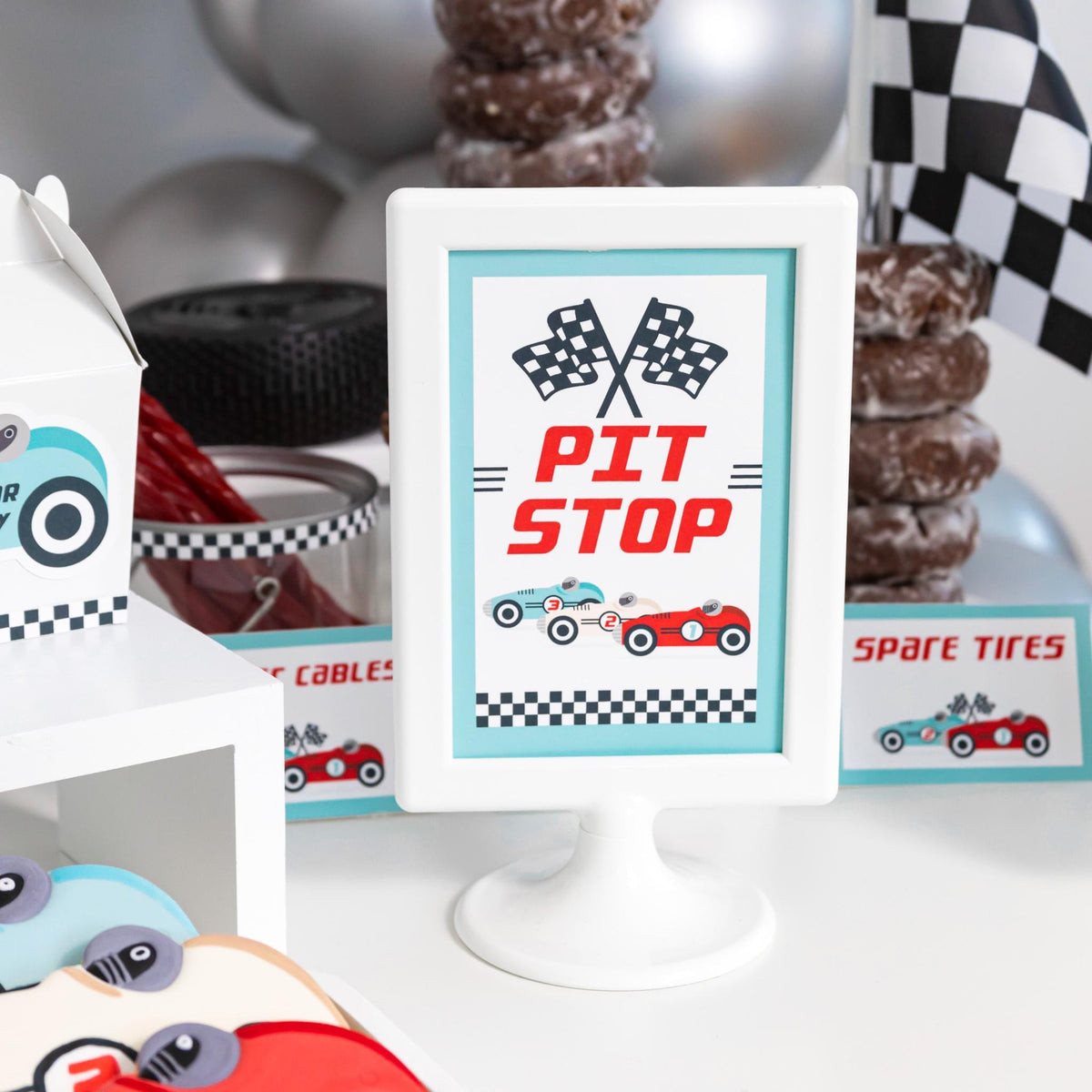 Pit Stop Vintage Race Car Sign - framed "Pit Stop" sign with checkered flags and vintage race cars beside a donut stack and silver balloons